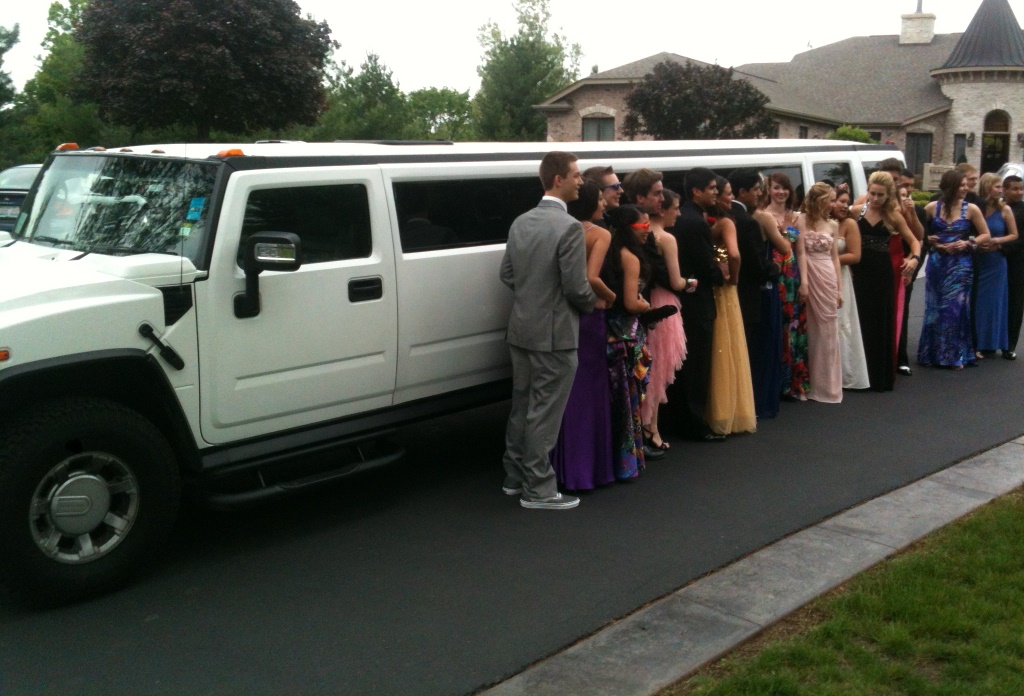 people standing next to white limo