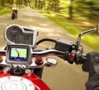 A man's hand on motorbike streer with navigation