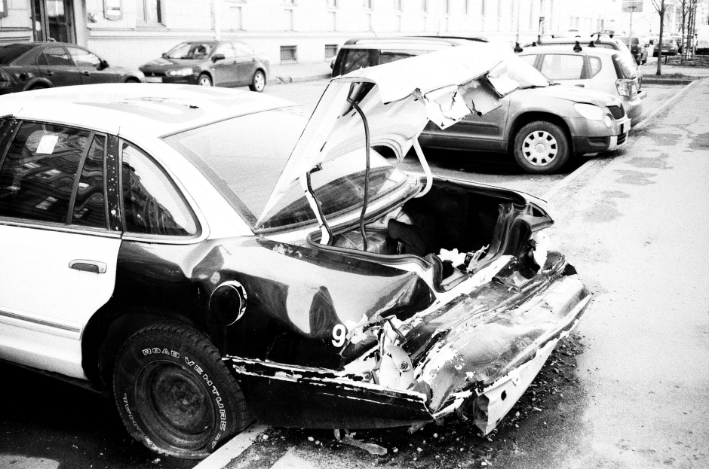a black and whit shot of a damaged car